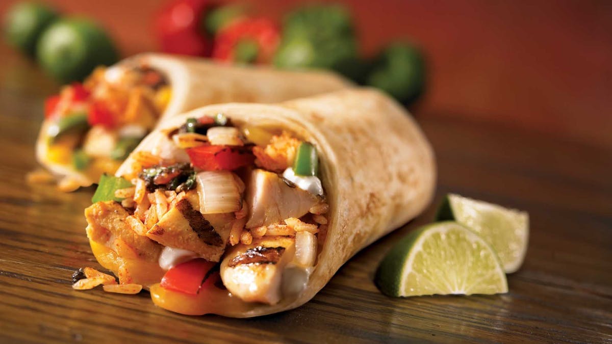 A chicken wrap cut and plated with lime